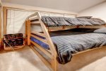 Captain bunk beds with a twin bed on top and a double bed on the bottom. Located behind the curtain off the dining room.